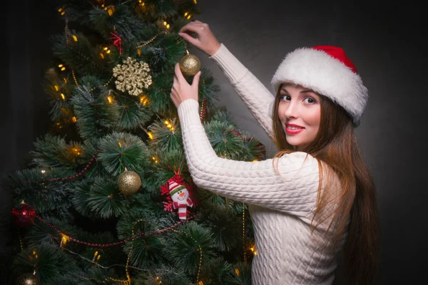 Happy woman decorating a christmas tree Stock Image