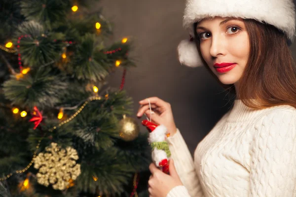 Happy woman decorating a christmas tree — Stock Photo, Image