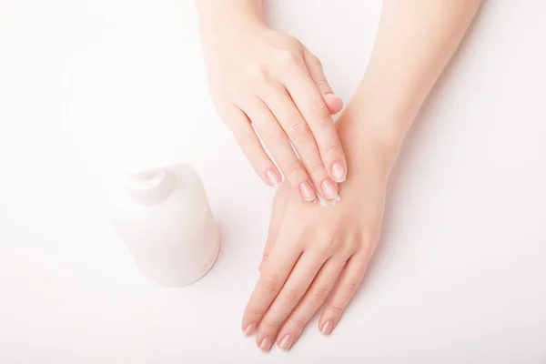 Beautiful female hand applying cream — Stock Photo, Image