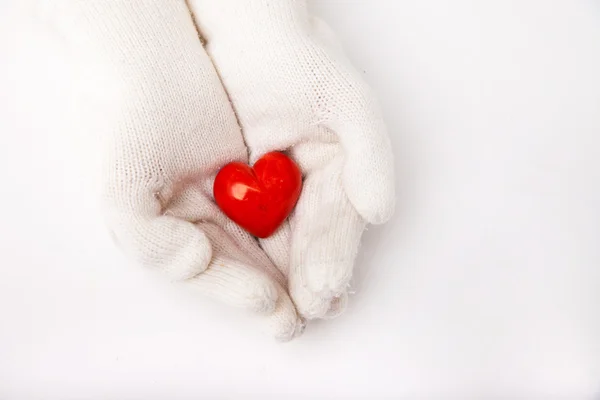 Woman hands in white gloves holding heart symbol — Stock Photo, Image