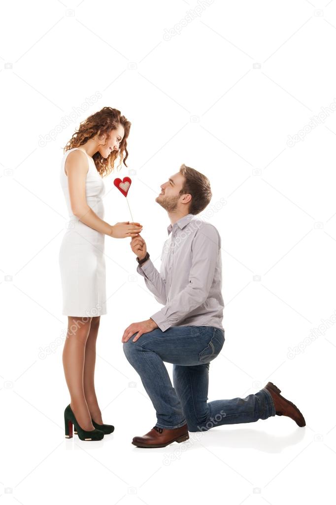 Joyful couple holding red heart
