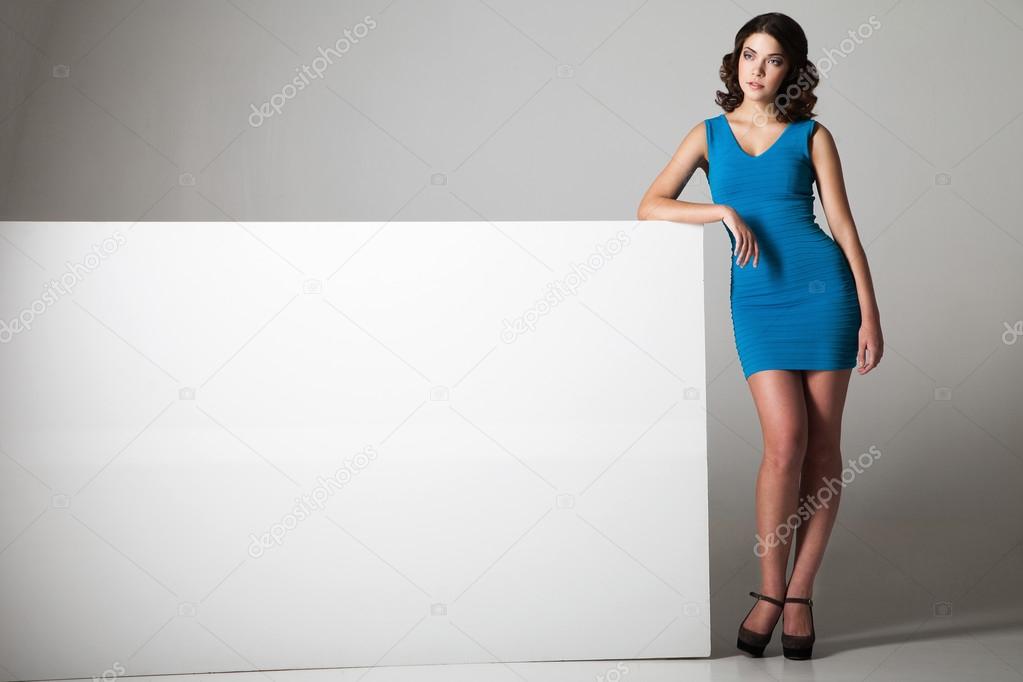 Woman standing near blank board