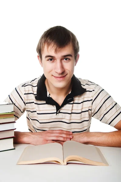 Estudiante masculino en la mesa con un montón de libros —  Fotos de Stock