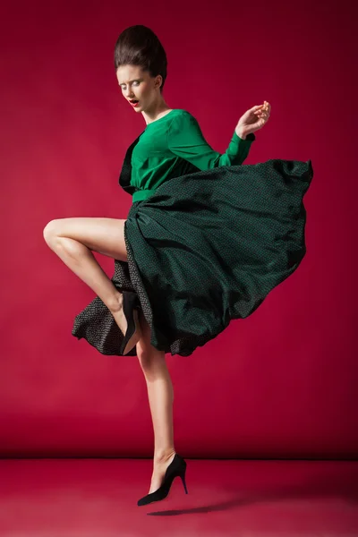 Beautiful brunette in gorgeous dress, motion shot — Stock Photo, Image