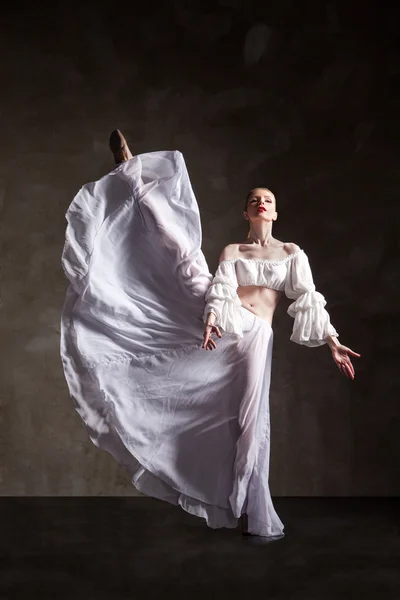 Young beautiful dancer posing on gray background — Stock Photo, Image