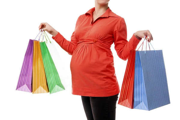 Těhotná žena drží nákupní tašky, samostatný — Stock fotografie