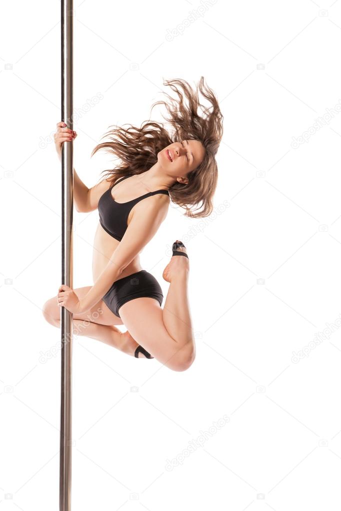 Young sexy woman exercise pole dance against white