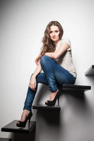 Sexy woman sitting on stairs — Stock Photo, Image