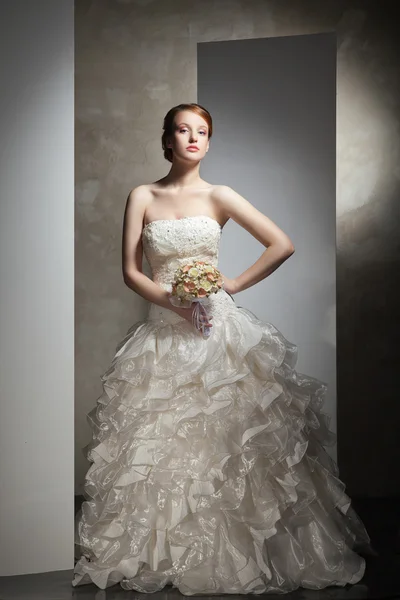 The beautiful young woman in a wedding dress — Stock Photo, Image