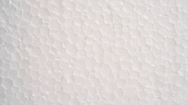 White foam sheet top view. Small and large clear foam beads, polystyrene sheet surface in closeup, close-up seamless background