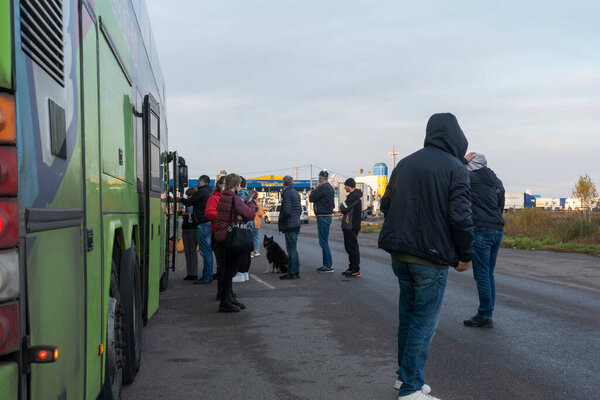 Бачевск. Украина. Октябрь 2021: Пассажиры международного автобуса на границе Украины в ожидании поездки