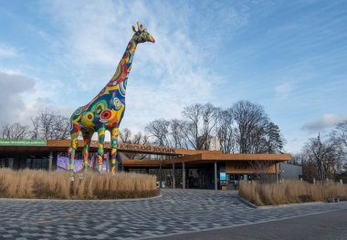 A sculpture of a painted giraffe at the entrance to the Kiev Zoo