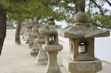 Row of stone lanterns in Japan clipart