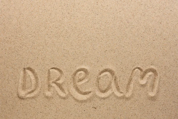 The word dream written on the sand — Stock Photo, Image