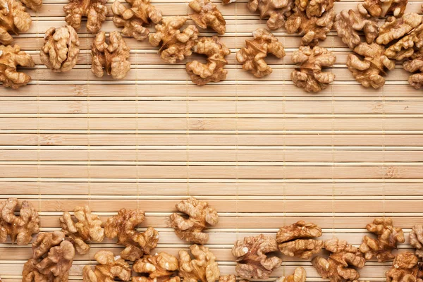 Walnut lies on the a bamboo mat — Stock Photo, Image