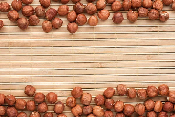 Hazelnut lies on the a bamboo mat — Stock Photo, Image