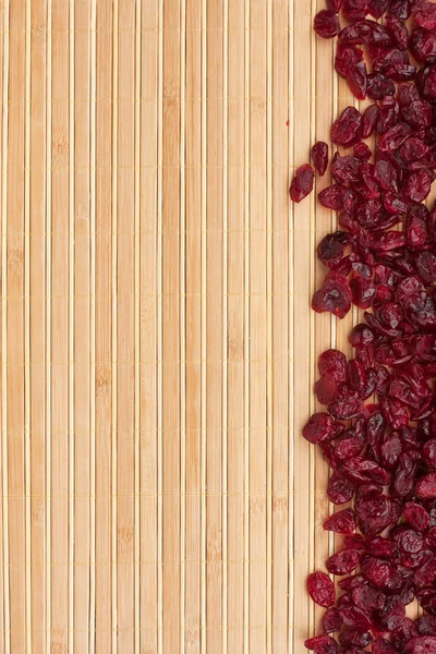 Dried cranberry lying on a bamboo mat — Stock Photo, Image