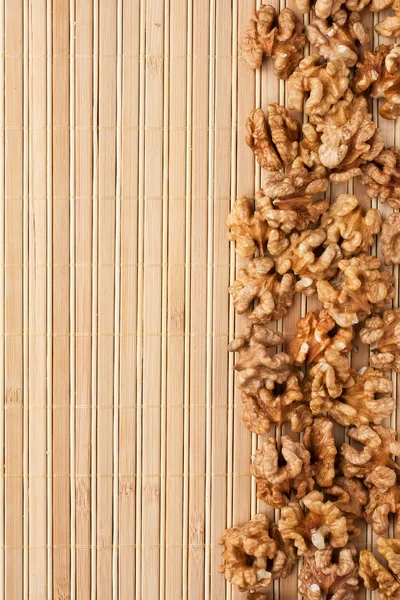 Walnut lying on a bamboo mat — Stock Photo, Image