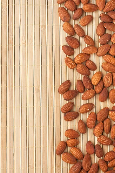 Almond lying on a bamboo mat — Stock Photo, Image