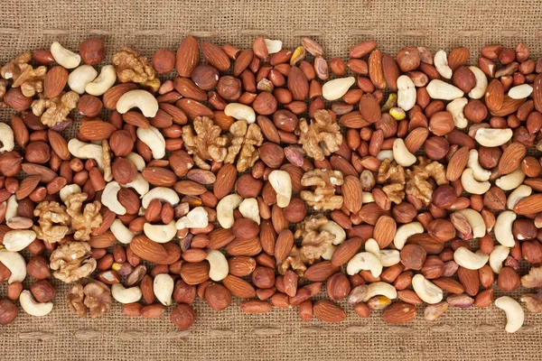 Line,dried nuts and burlap — Stock Photo, Image