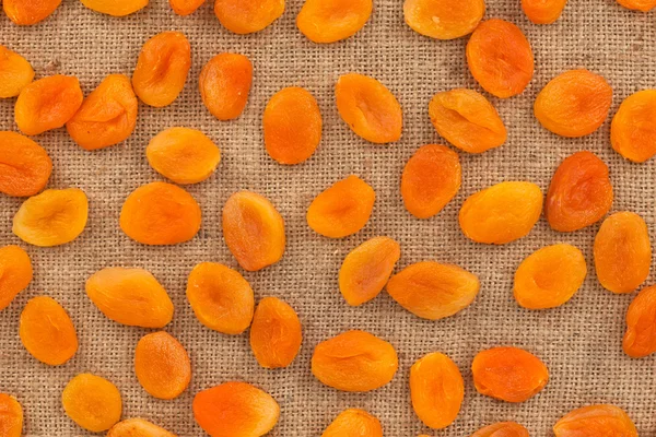 Background, apricots lying on sackcloth — Stock Photo, Image