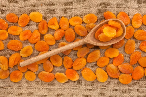 Wooden spoon with dried apricots — Stock Photo, Image