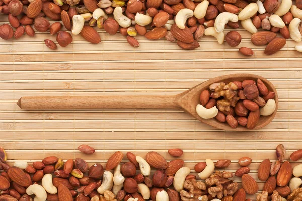 Wooden spoon with dried nuts — Stock Photo, Image