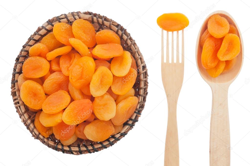 Spoon, a fork, a plate with dried apricots