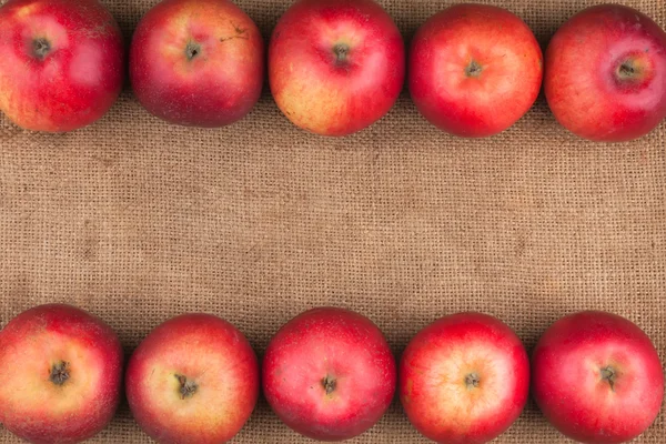 Red apples lie on sackcloth — Stock Photo, Image