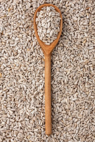 Wooden spoon with sunflower seeds — Stock Photo, Image