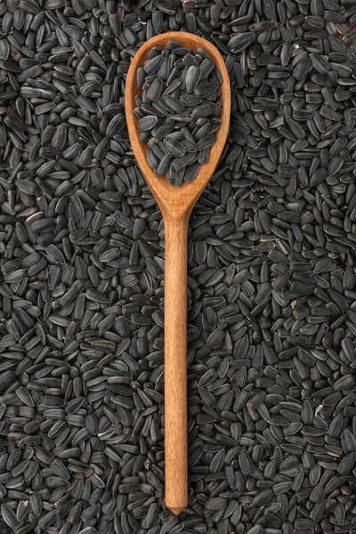Wooden spoon with sunflower seeds — Stock Photo, Image
