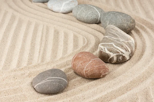 Striped stones on the sand — Stock Photo, Image