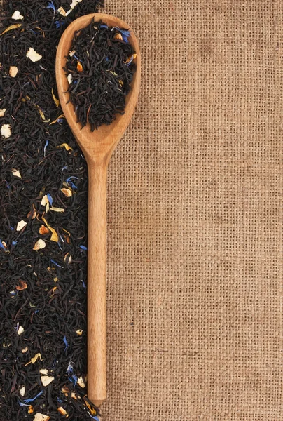 Spoon with black tea — Stock Photo, Image