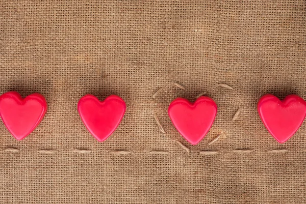 Five hearts on sackcloth — Stock Photo, Image