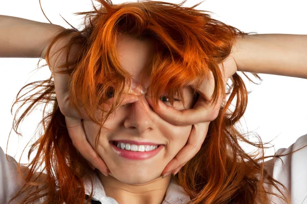 Red-haired girl makes out of its hands symbolic glasses