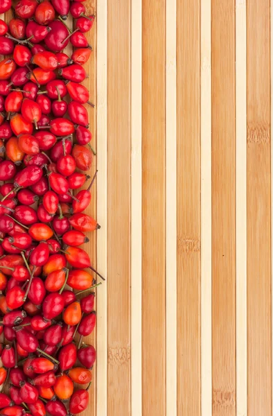 Rosehip on a bamboo mat — Stock Photo, Image