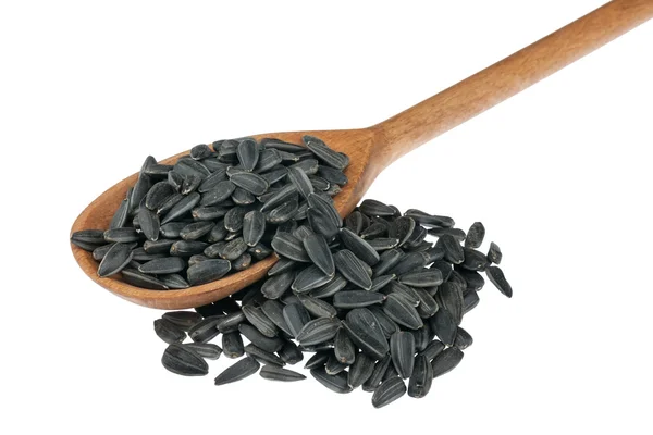 Wooden spoon with sunflower seeds — Stock Photo, Image