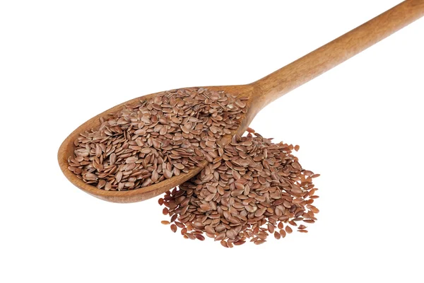 Wooden spoon with flax seeds — Stock Photo, Image