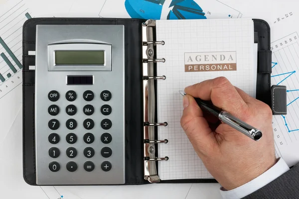 Businessman writes in a diary — Stock Photo, Image