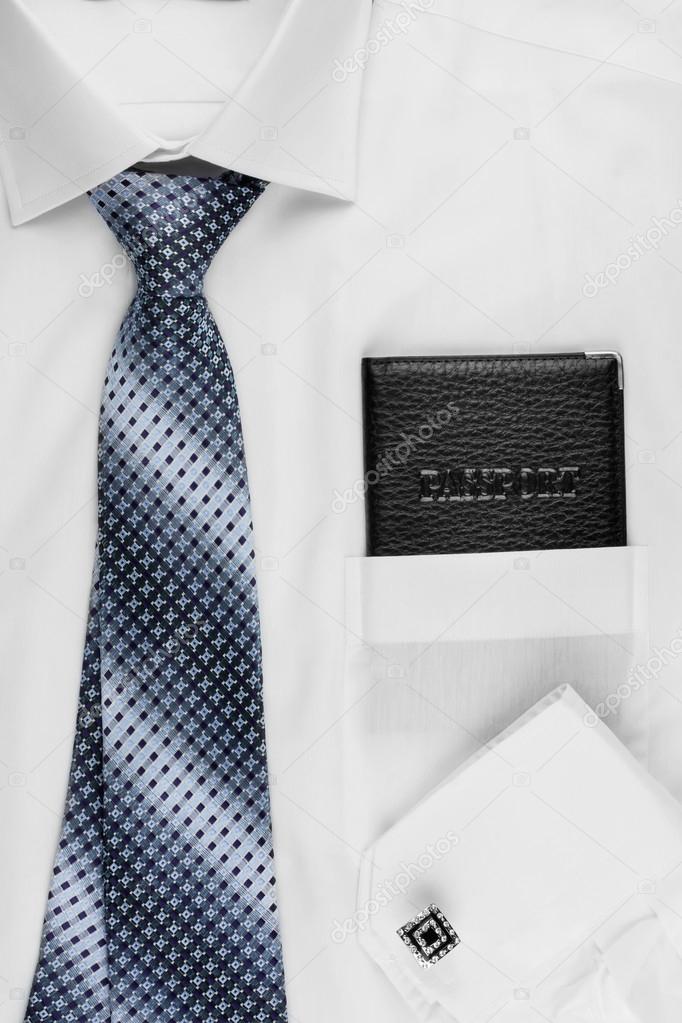 Passport lying on the shirt  and tie