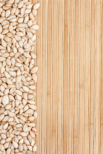 Pumpkin seed  on a bamboo mat — Stock Photo, Image