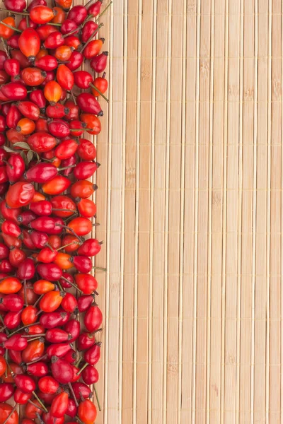 Rosehip on a bamboo mat — Stock Photo, Image