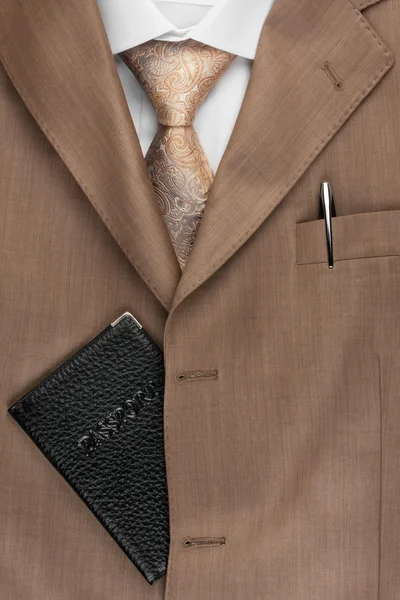 Passport lying on the jacket, tie and shirt — Stock Photo, Image