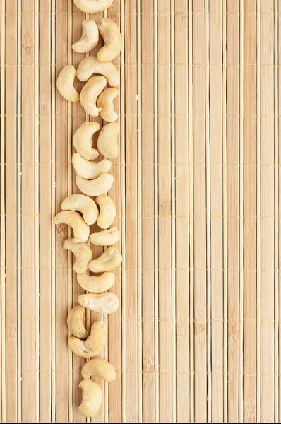 Cases a band of  cashew   lying on bamboo mat — Stock Photo, Image