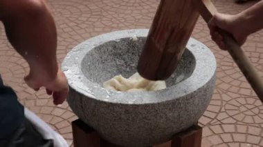 Japanese New Year's Food Tradition, Beating Rice Cakes in a Big Stone Bowl