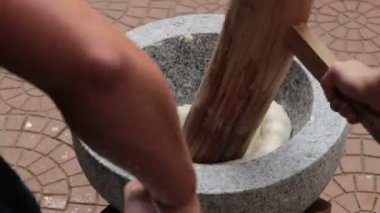 Japanese New Year's Food Tradition, Beating Rice Cakes in a Big Stone Bowl