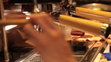 Making coffee with a coffee machine in a cafe
