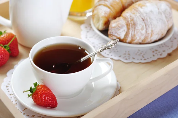 Breakfast with tea and croissants — Stock Photo, Image