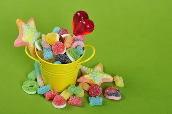 Candies in yellow bucket — Stock Photo, Image