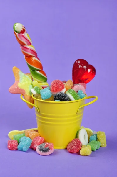 Candies in yellow bucket — Stock Photo, Image